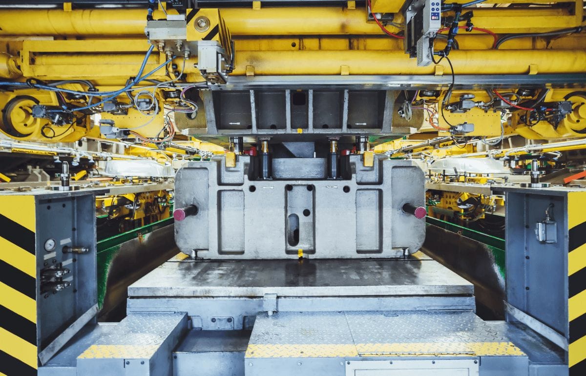 Metal stamping press in operation in factory setting